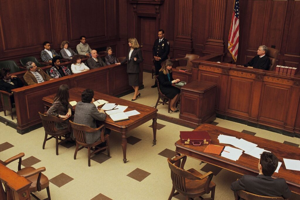 California courtroom hearing with judge, defense attorneys, and jury